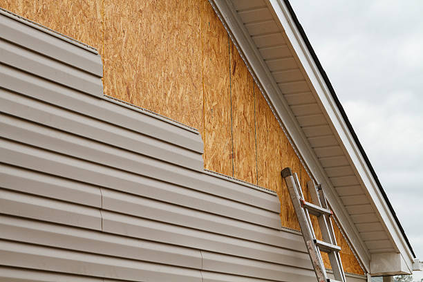 Professional Storm Damage Siding Repair technician working in Wilmot, OH